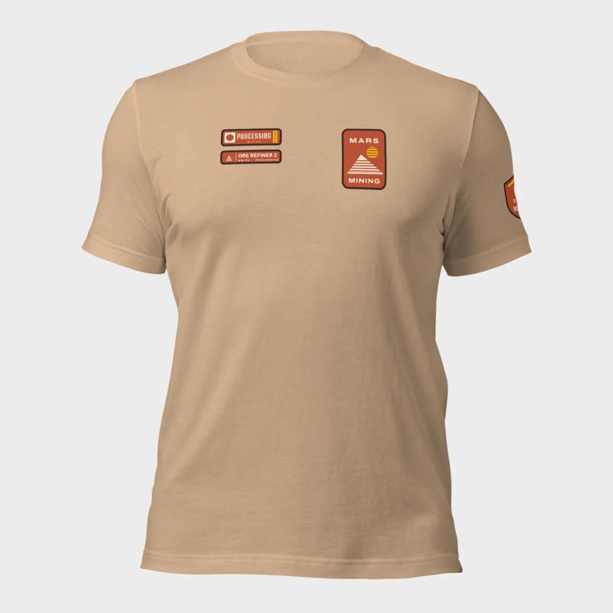 Bella+Canvas 3001 tee in tan with the Mars Mining badge on the left chest and the Processing department tag and rank patch on the right chest