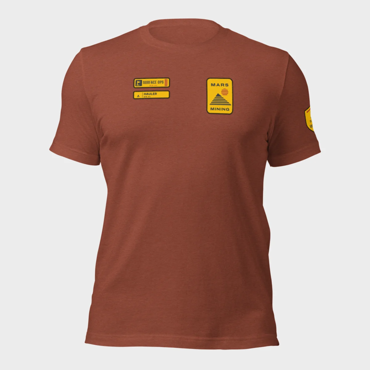 Bella+Canvas 3001 tee in heather clay with the Mars Mining badge on the left chest and the Surface Ops department tag and rank patch on the right chest