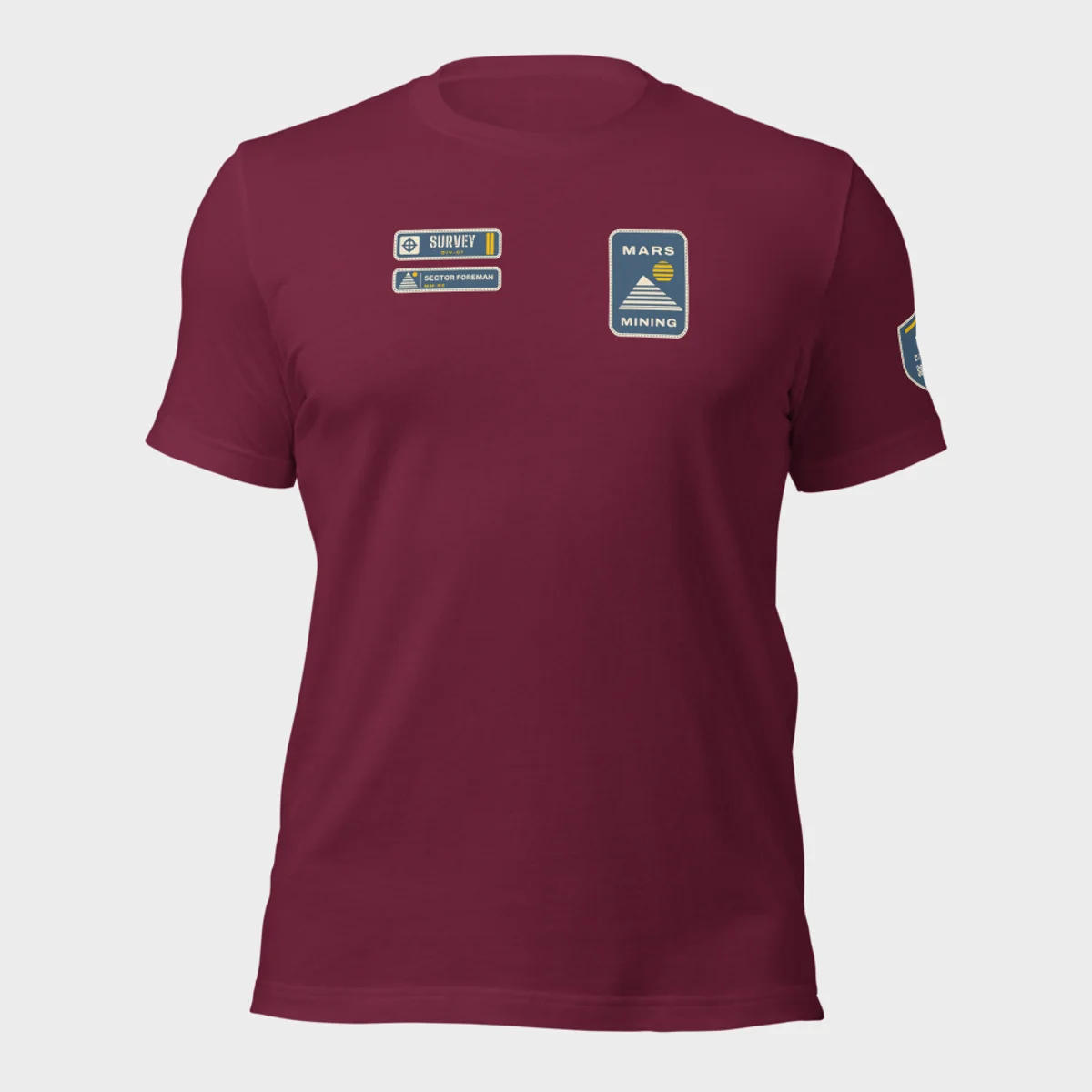 Bella+Canvas 3001 tee in maroon with the Mars Mining badge on the left chest and the Survey department tag and rank patch on the right chest